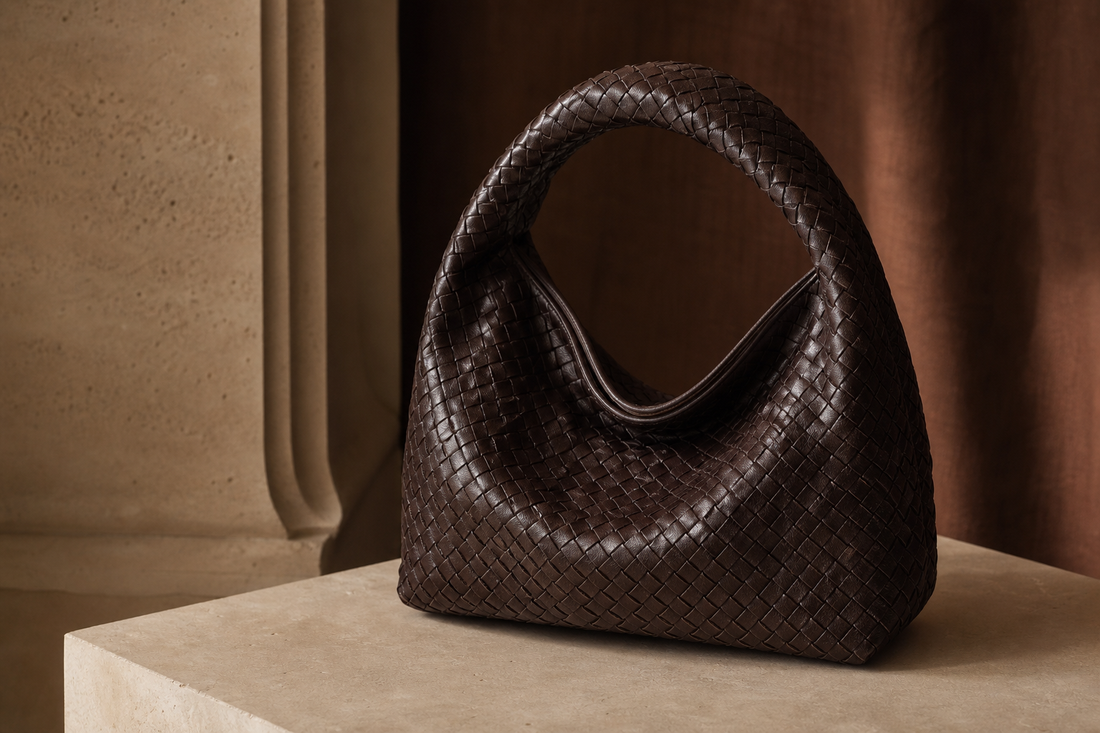 Logo-free editorial image of a dark woven leather hobo bag for a pre-owned Fendi Spy Bag buying guide