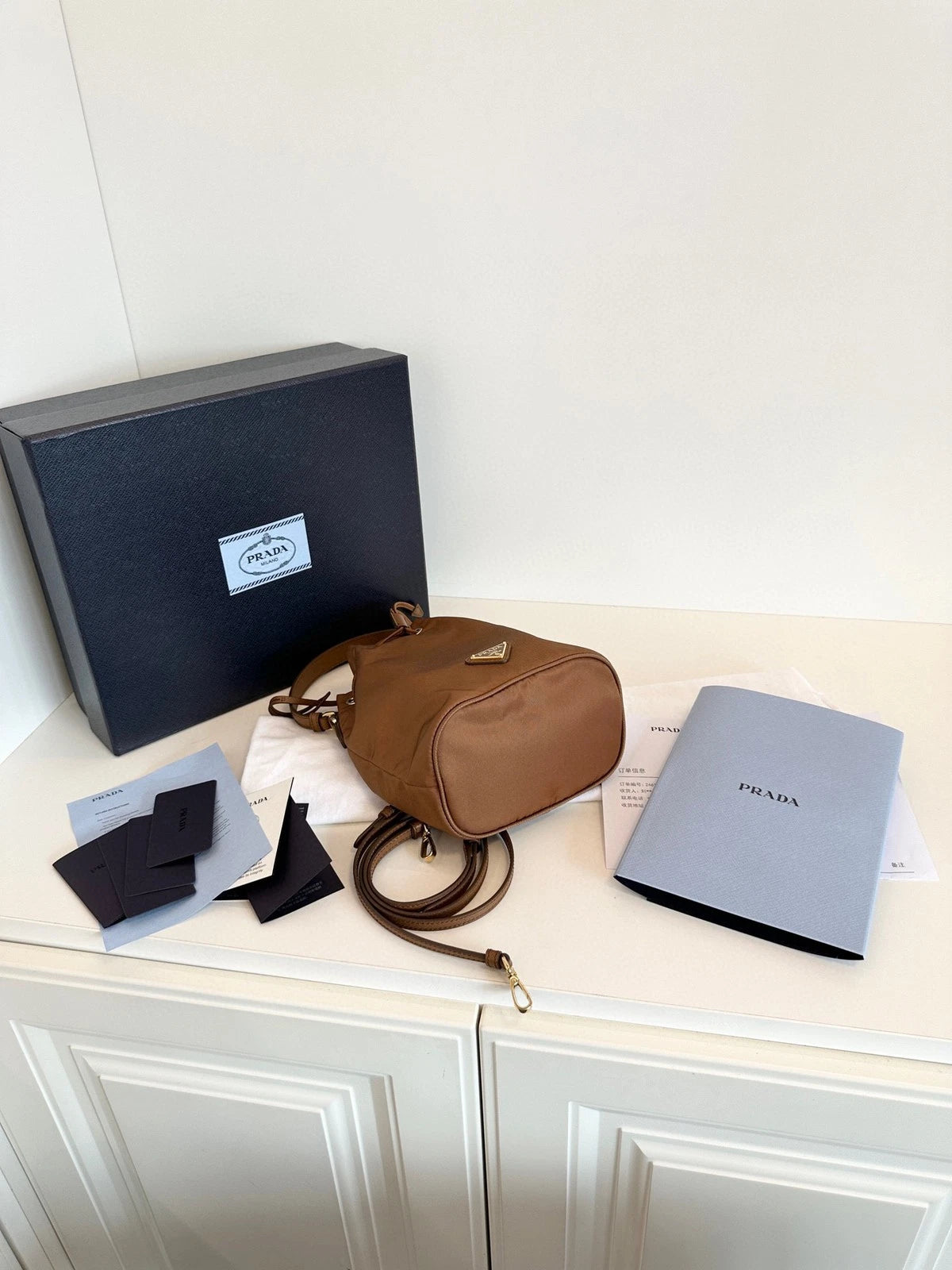 Prada Re-Edition Re-Nylon Mini Bucket Bag Gold Brown Drawstring Parachute