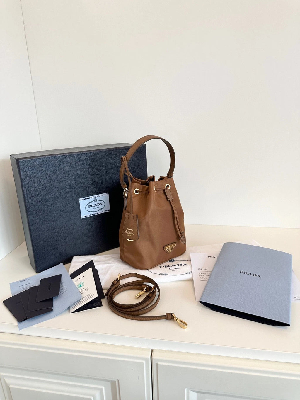 Prada Re-Edition Re-Nylon Mini Bucket Bag Gold Brown Drawstring Parachute