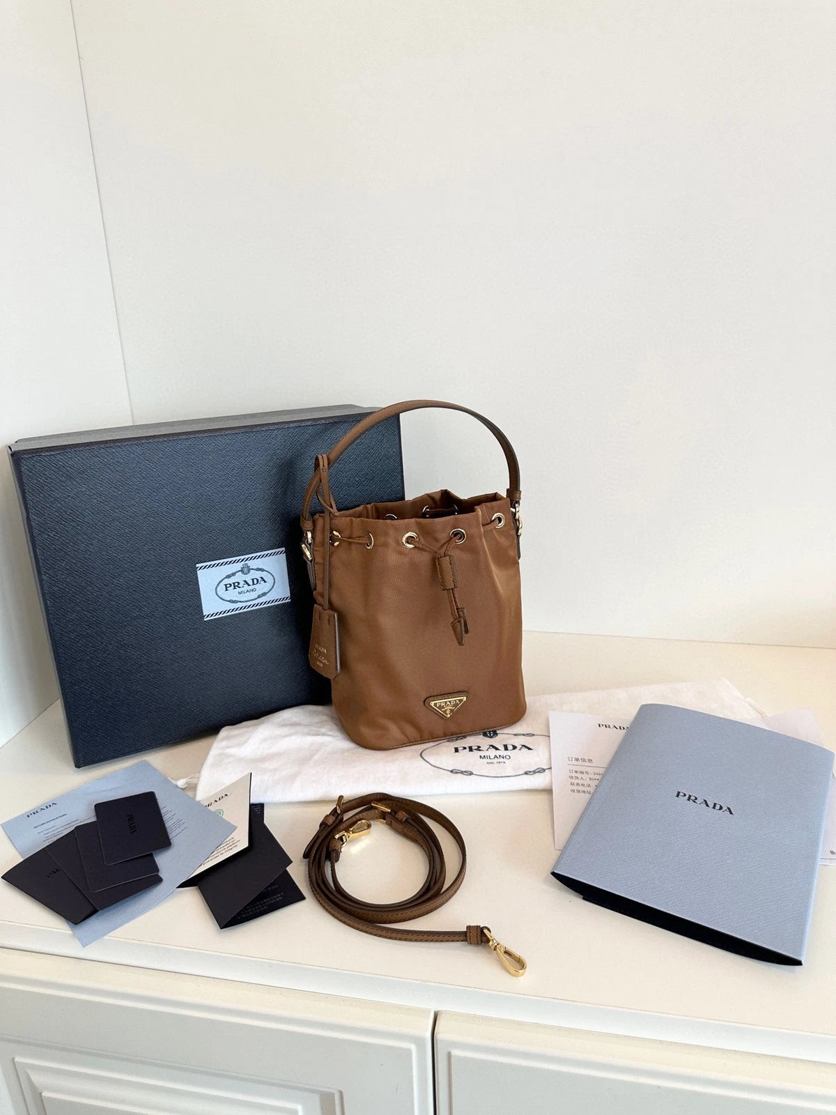 Prada Re-Edition Re-Nylon Mini Bucket Bag Gold Brown Drawstring Parachute