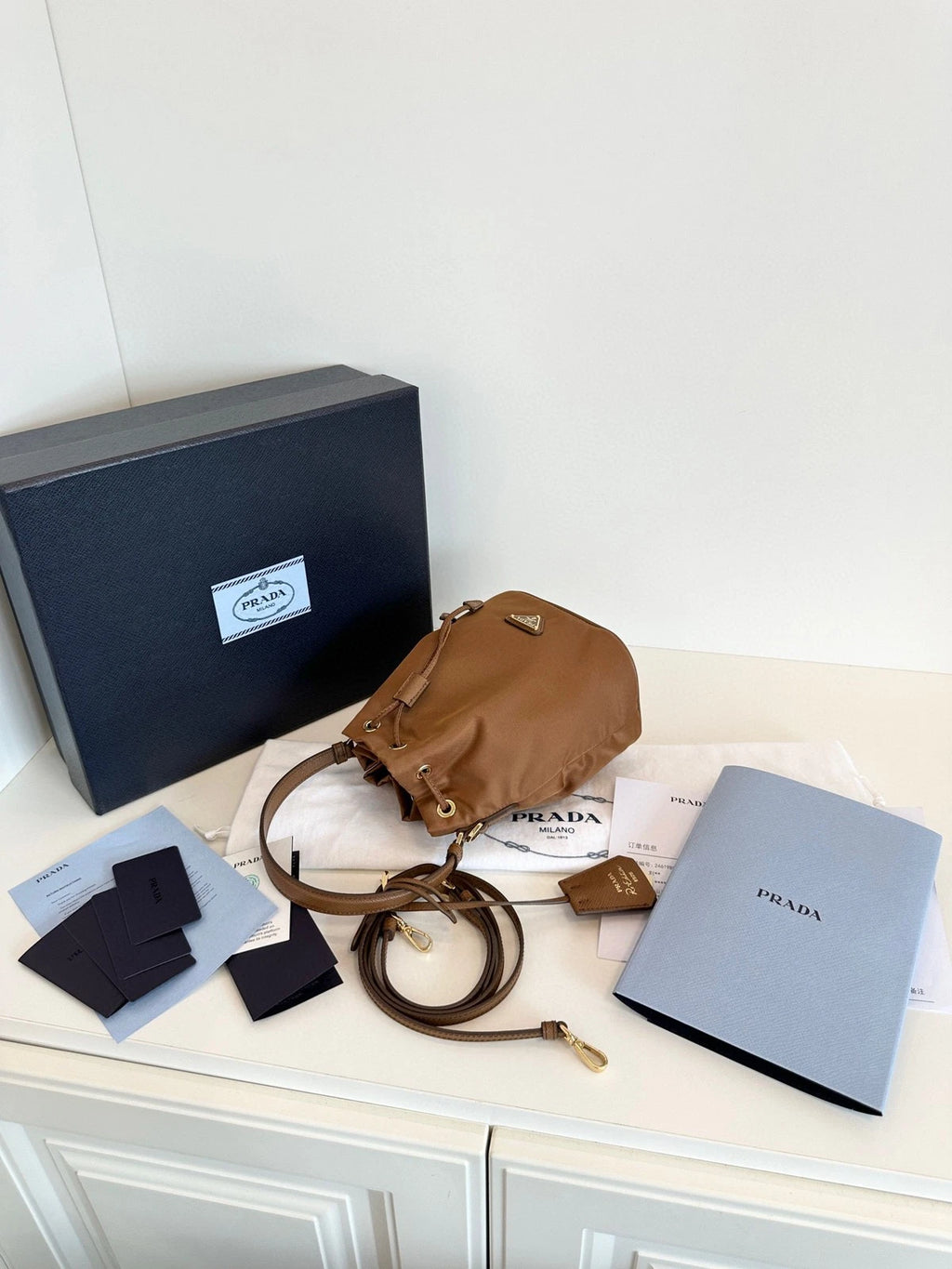 Prada Re-Edition Re-Nylon Mini Bucket Bag Gold Brown Drawstring Parachute